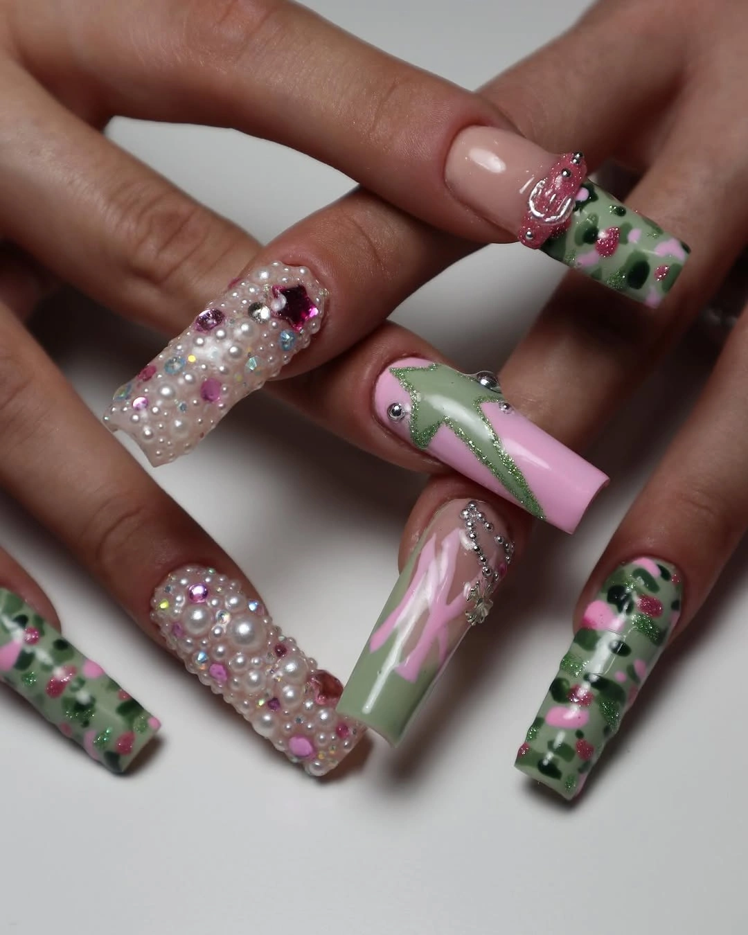 Extra-long square nails with green patterns, pearl-like beads and pink accents