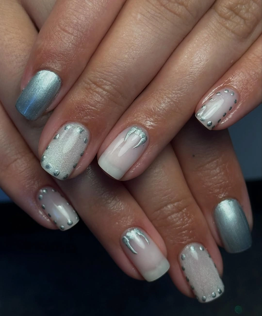 Soft-square blue and milky white nails with silver shimmer and bead-like accents